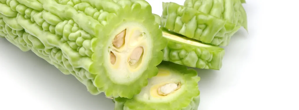 Sliced bitter melon on a white background.