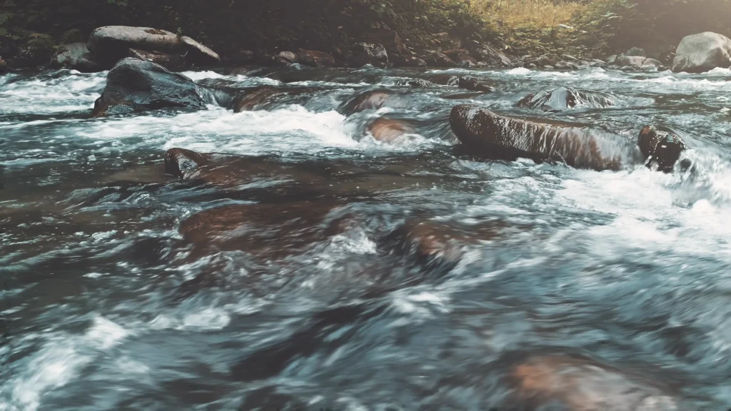 A mountain river flowing over rocks and a good source of tap water.