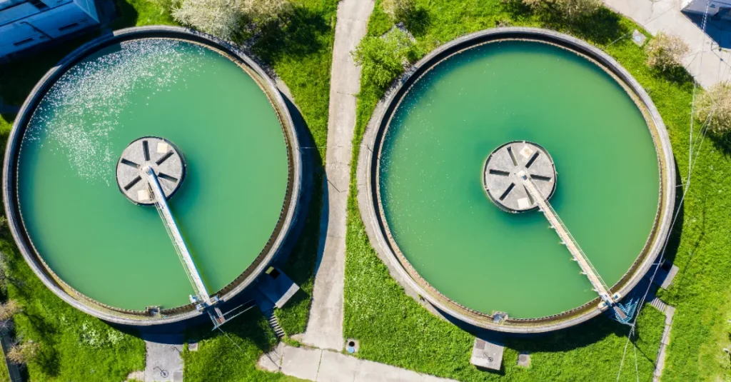 Aerial view of water sedimentation tanks at a water treatment plant. 