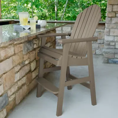 A light brown tall Hamilton deck chair on the patio.