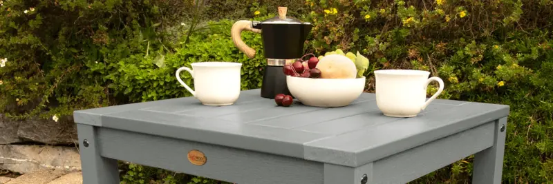 Outdoor square table with coffee setting.